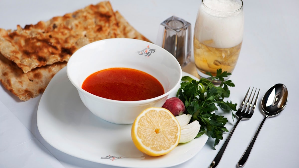 orange fruit beside white ceramic bowl with soup